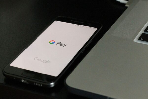 black Android smartphone near laptop computer