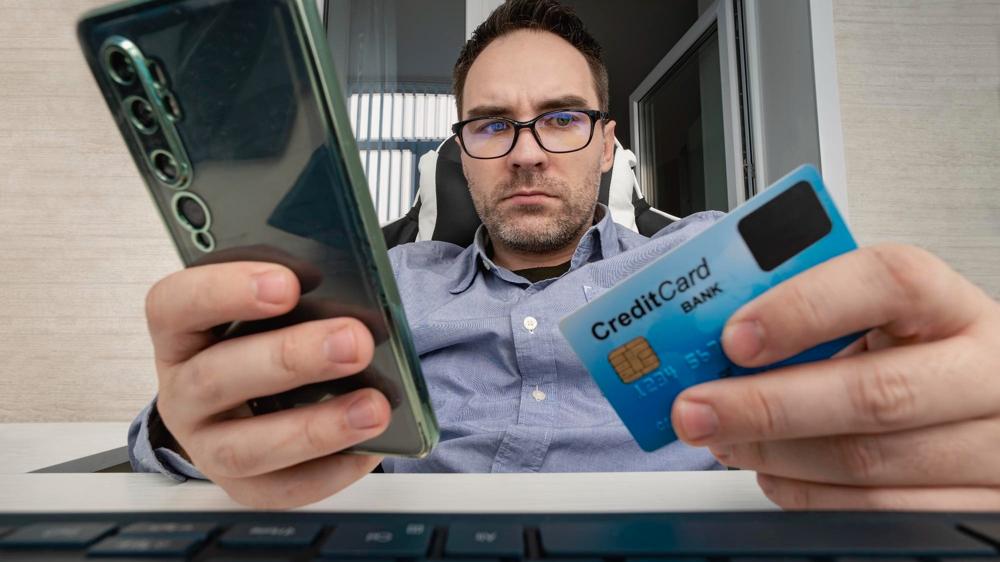 Businessman hand holding credit card to online shopping from home with laptop payment ecommerce internet banking man enters the card details on the website
