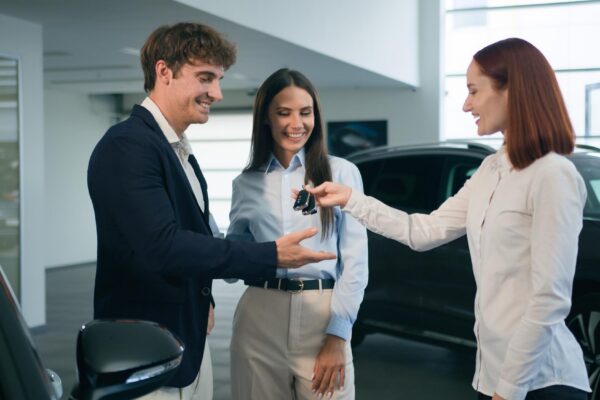 Happy smiling customers family caucasian couple man woman buy new car smile clients buyers female