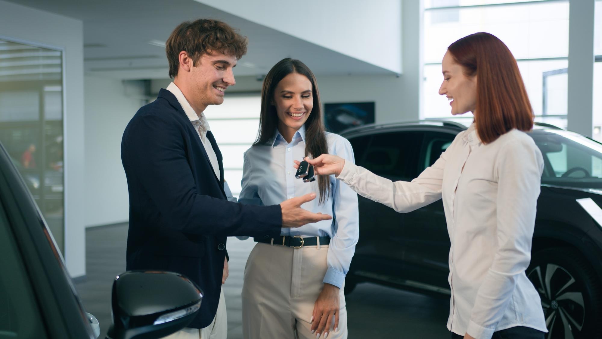Happy smiling customers family caucasian couple man woman buy new car smile clients buyers female