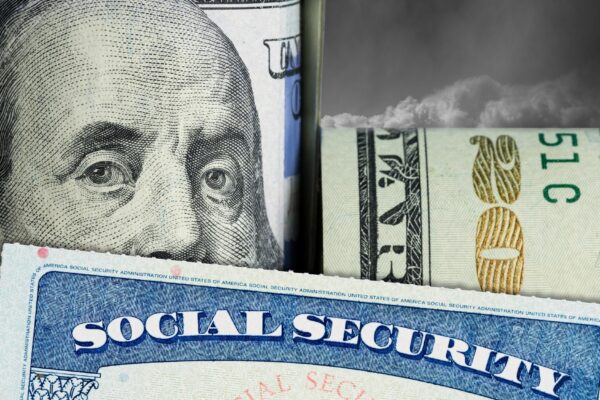 Social Security Card in front of Benjamin Franklin on dollar note