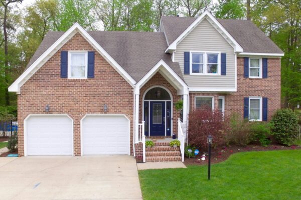 a large brick house with two garages