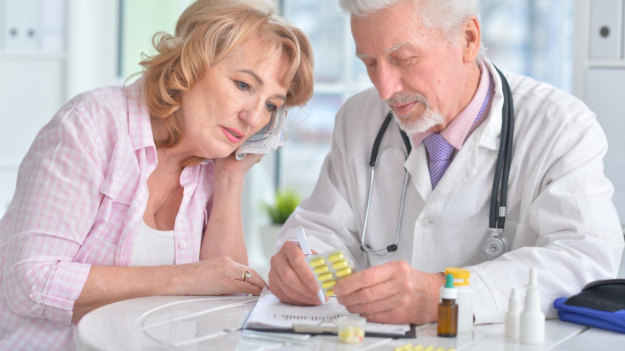 Close up portrait of senior doctor with elderly patient