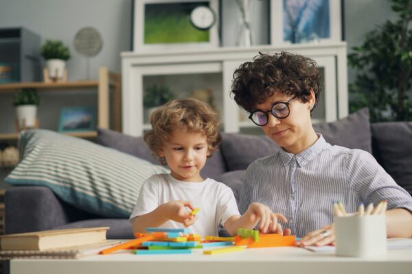 a woman and a child are sitting at a table