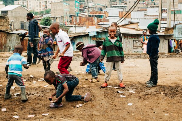 children playing on brown sand at daytime