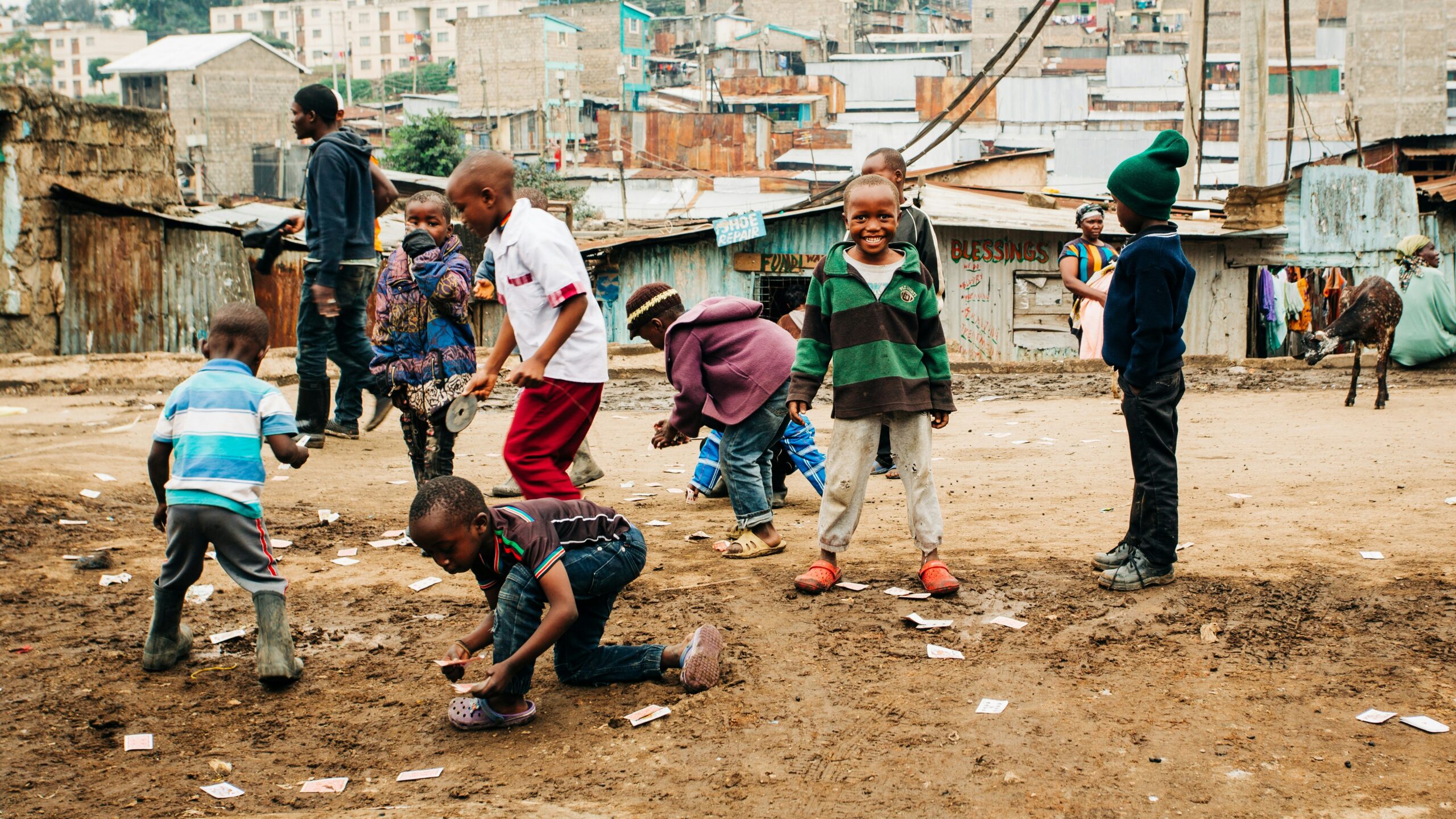 children playing on brown sand at daytime