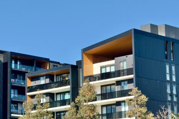 Modern apartment buildings against a blue sky.