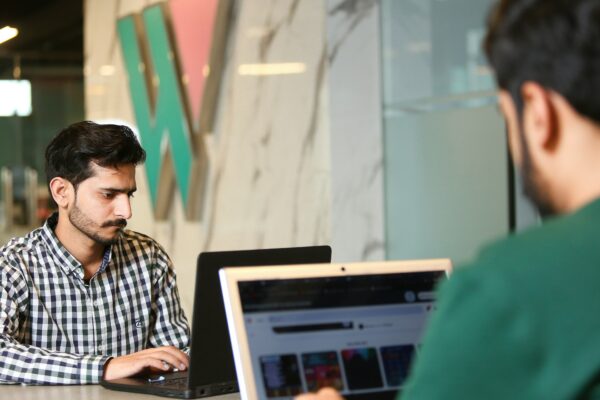 a man sitting in front of a laptop computer