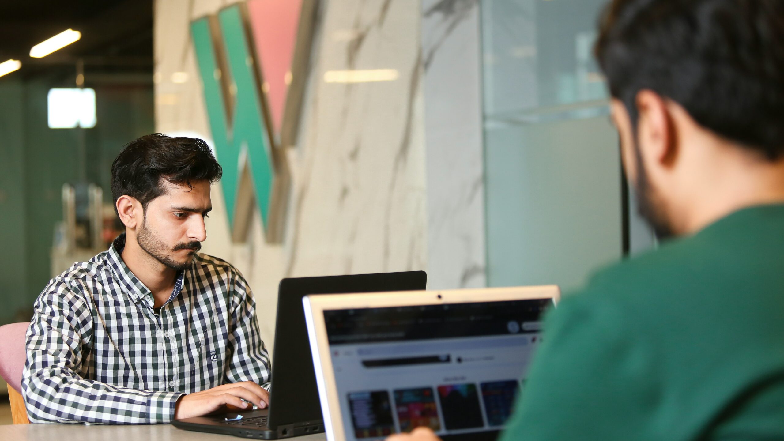 a man sitting in front of a laptop computer