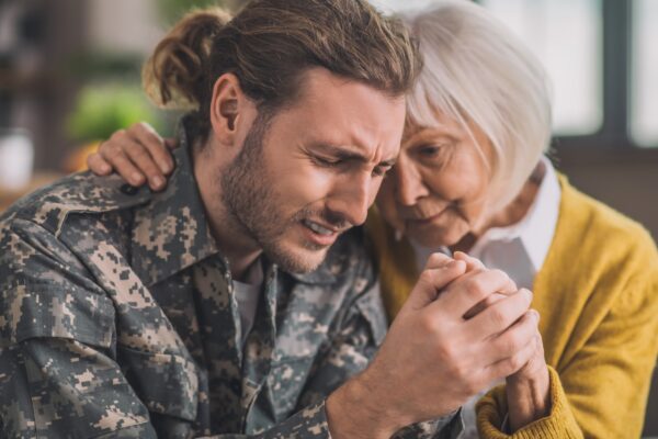 Mom hugging her son in uniform