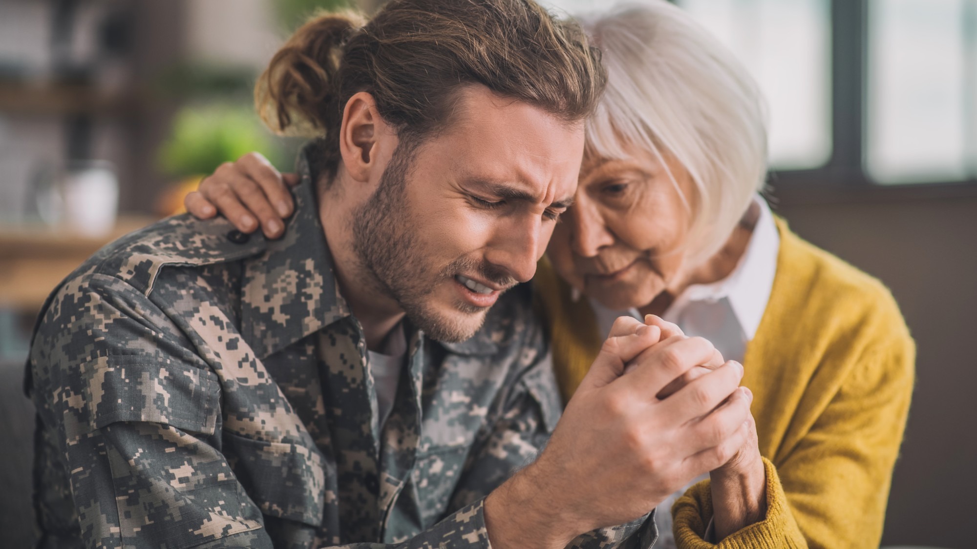 Mom hugging her son in uniform