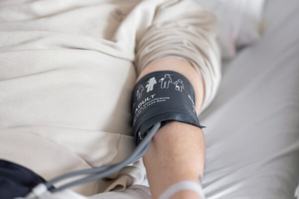 a man laying in a bed with a cast on his arm