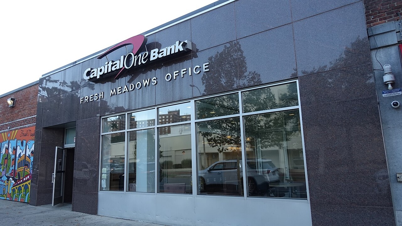 Looking at the Capital One Bank at the center of Building I from 188th Street in the western half of the Fresh Meadows Place Shopping Center, at 188th Street and 64th Avenue in Fresh Meadows, Queens. The bank retains the original stone (granite?) facade from the 1949 Jamaica Savings Bank.