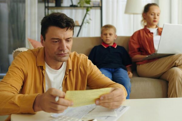 Father calculating family bills at home