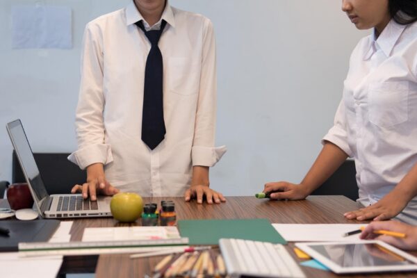 Midsection of design professionals working on table