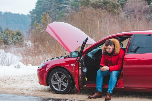 Man sitting in car calling for help break down at winter speedway
