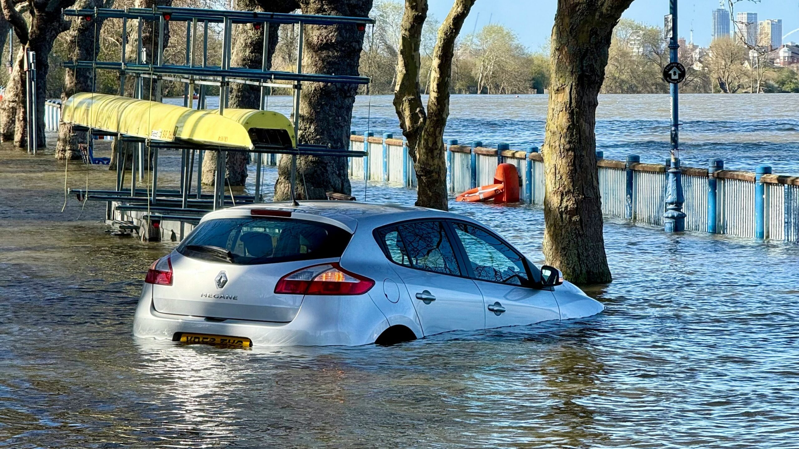 A car is submerged in floodwater.