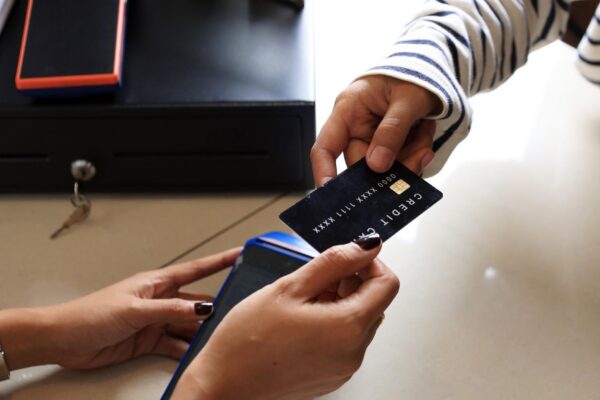 Close Up Female Customer Paying with Black Credit Card