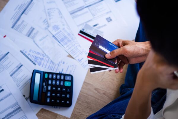 Business people are stressed about credit card debt and many bills on the floor