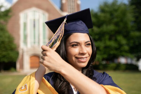 a woman in a graduation cap and gown