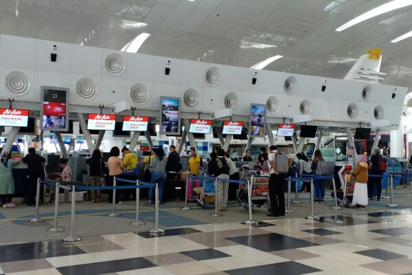 a group of people waiting in line at an airport