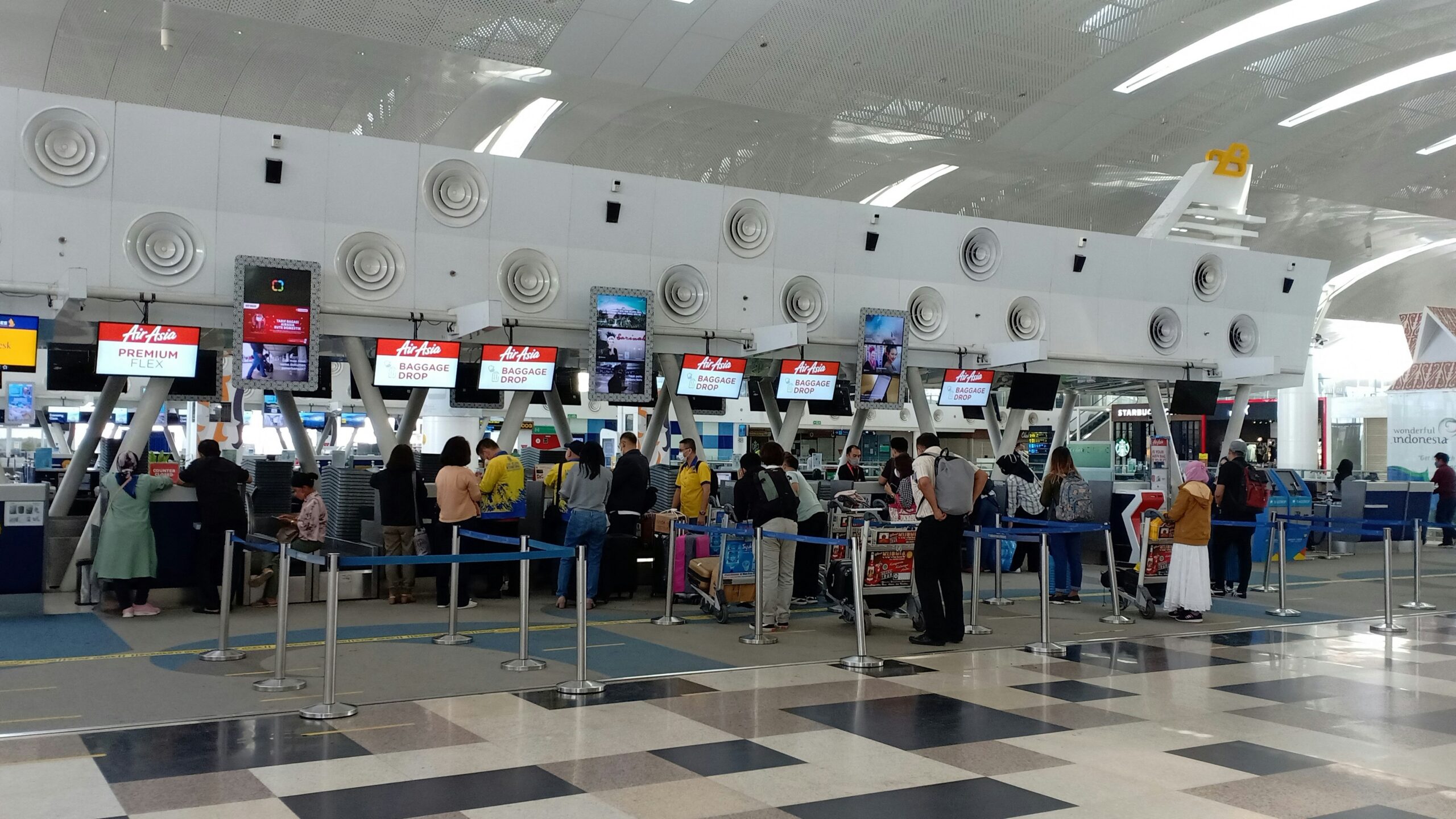 a group of people waiting in line at an airport