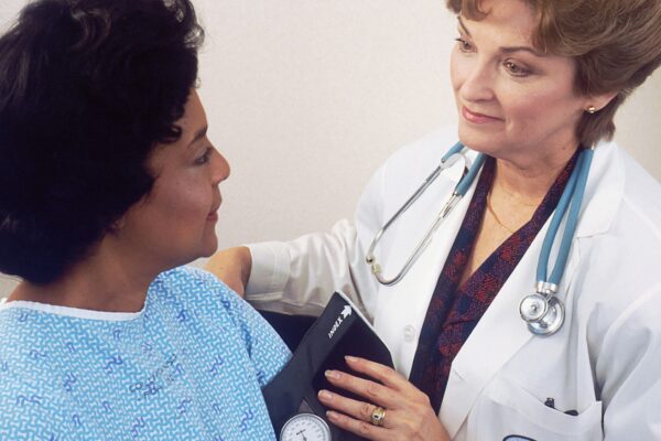 a woman with a stethoscope talking to another woman