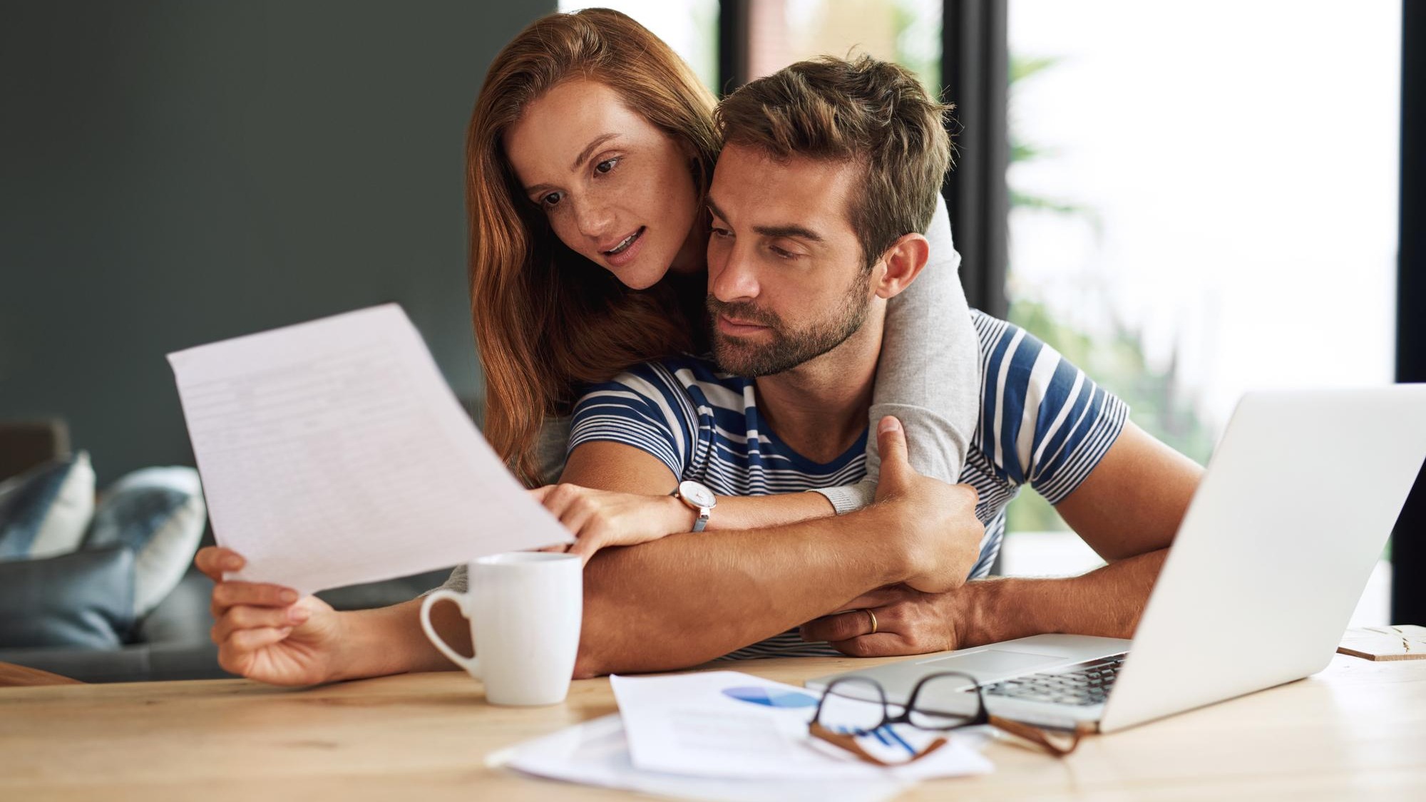 Finance laptop and tax with couple in home together for bank investment or savings Accounting budget or documents for wealth management with man and woman in planning on computer in apartment