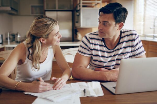 Finance fighting and couple with laptop with bills stress and internet banking issue in debt Home payment due and anxiety from mortgage tax audit or invoice with conversation about savings