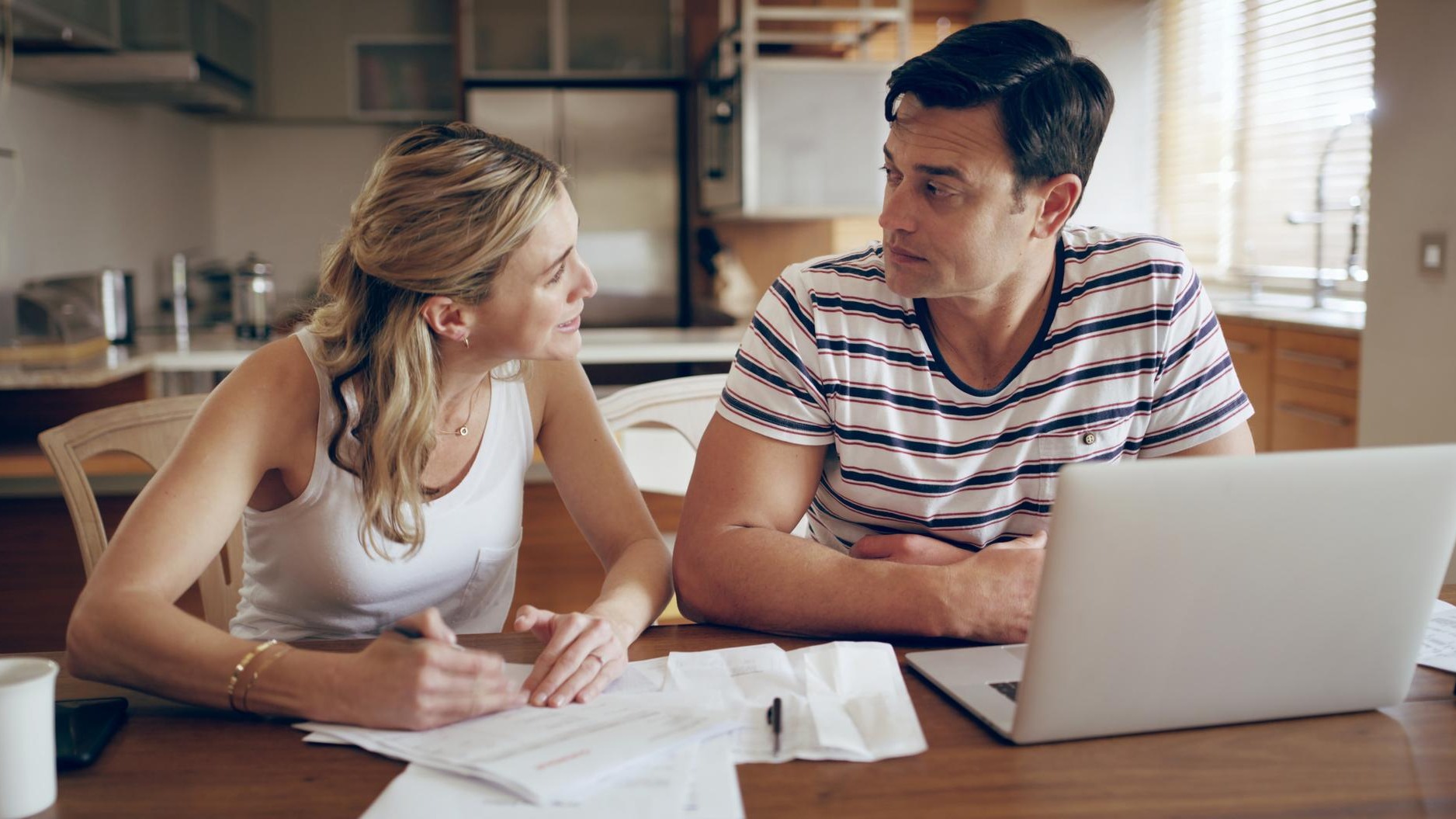 Finance fighting and couple with laptop with bills stress and internet banking issue in debt Home payment due and anxiety from mortgage tax audit or invoice with conversation about savings