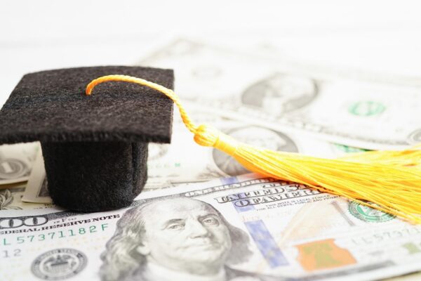 Graduation gap hat on US dollar banknotes money Education study fee learning teach concept