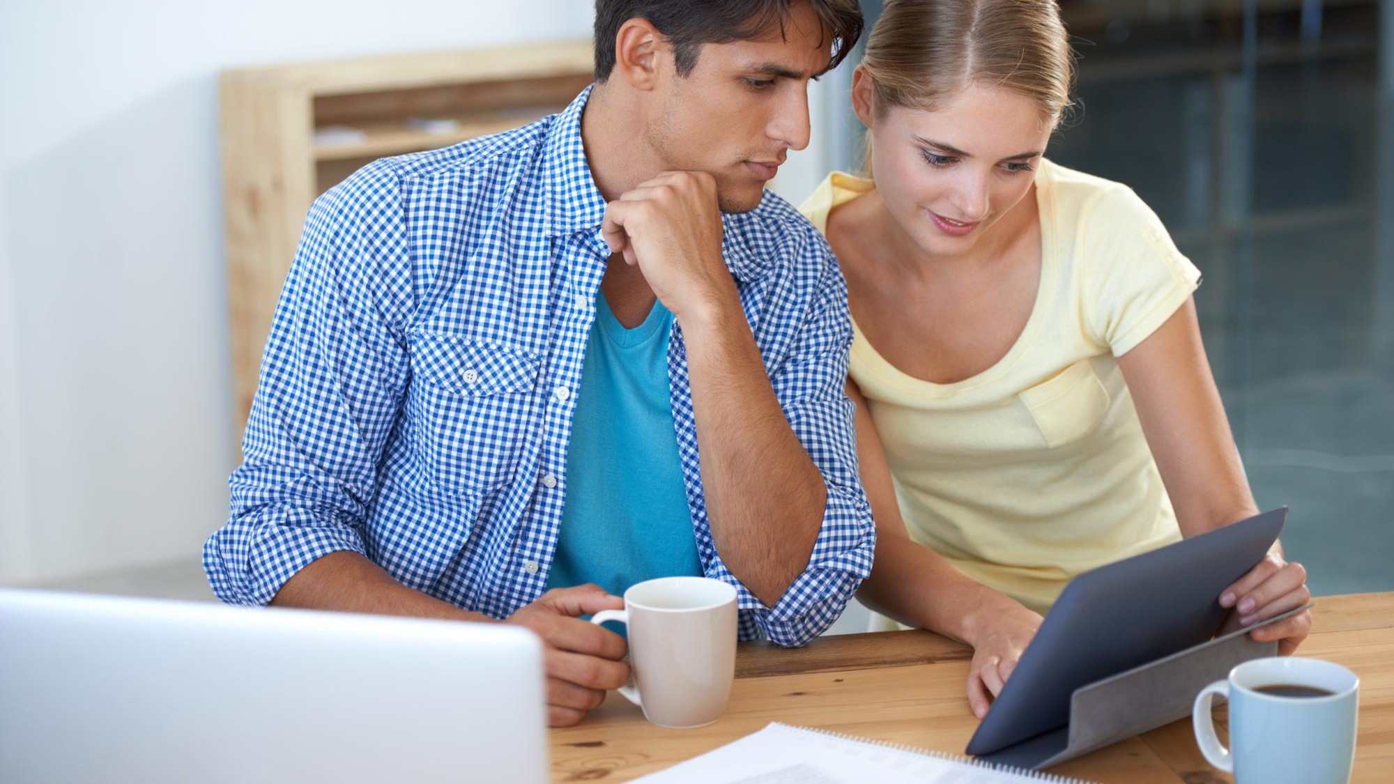 Teamwork business meeting and tablet with documents laptop and looking plan and workers with coffee Man woman and tech for email working or project for conversation workplace and professional
