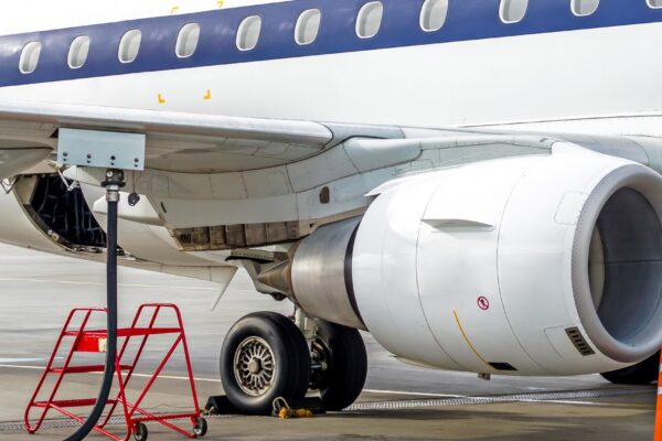 Fueling aircraft, view of the wing, hose, engine. Airport Service.