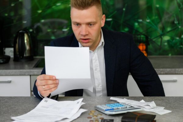 Man reading notice regarding late payments