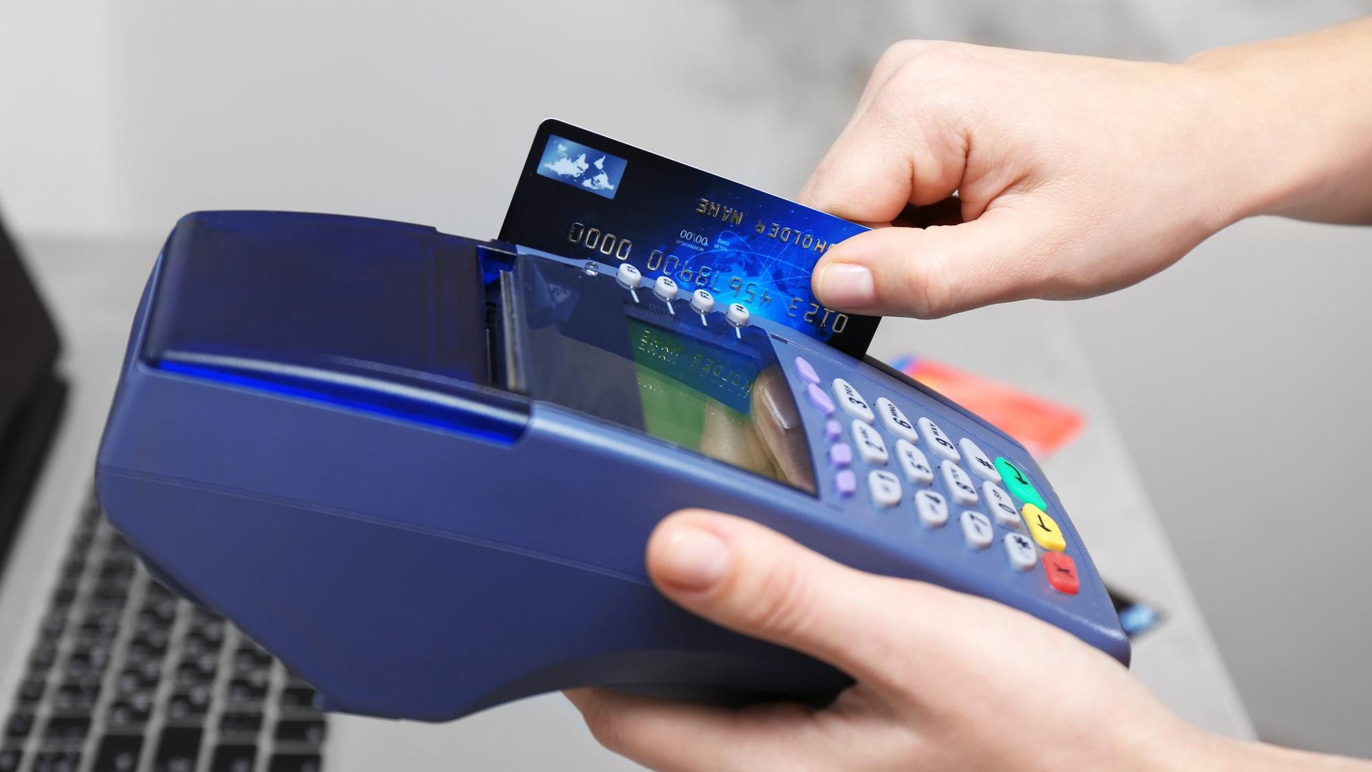 Hands using bank terminal for credit card payment