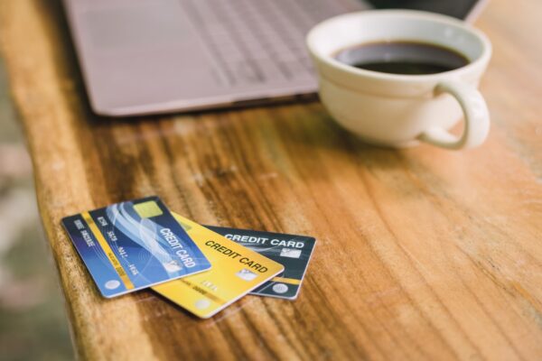 Credit card on laptop with coffee, outdoor