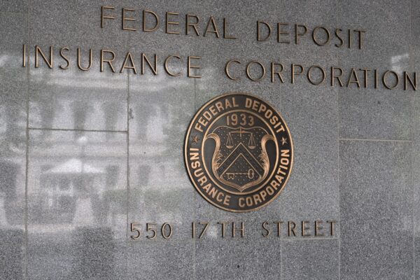 The sign for the Federal Deposit Insurance Corporation mounted on the exterior wall of a building. 550 17th Street NW, Washington, DC 20429.