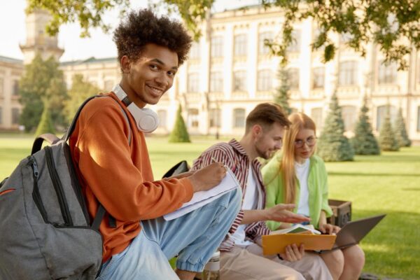 University students working on homework or creative project at campus outdoors