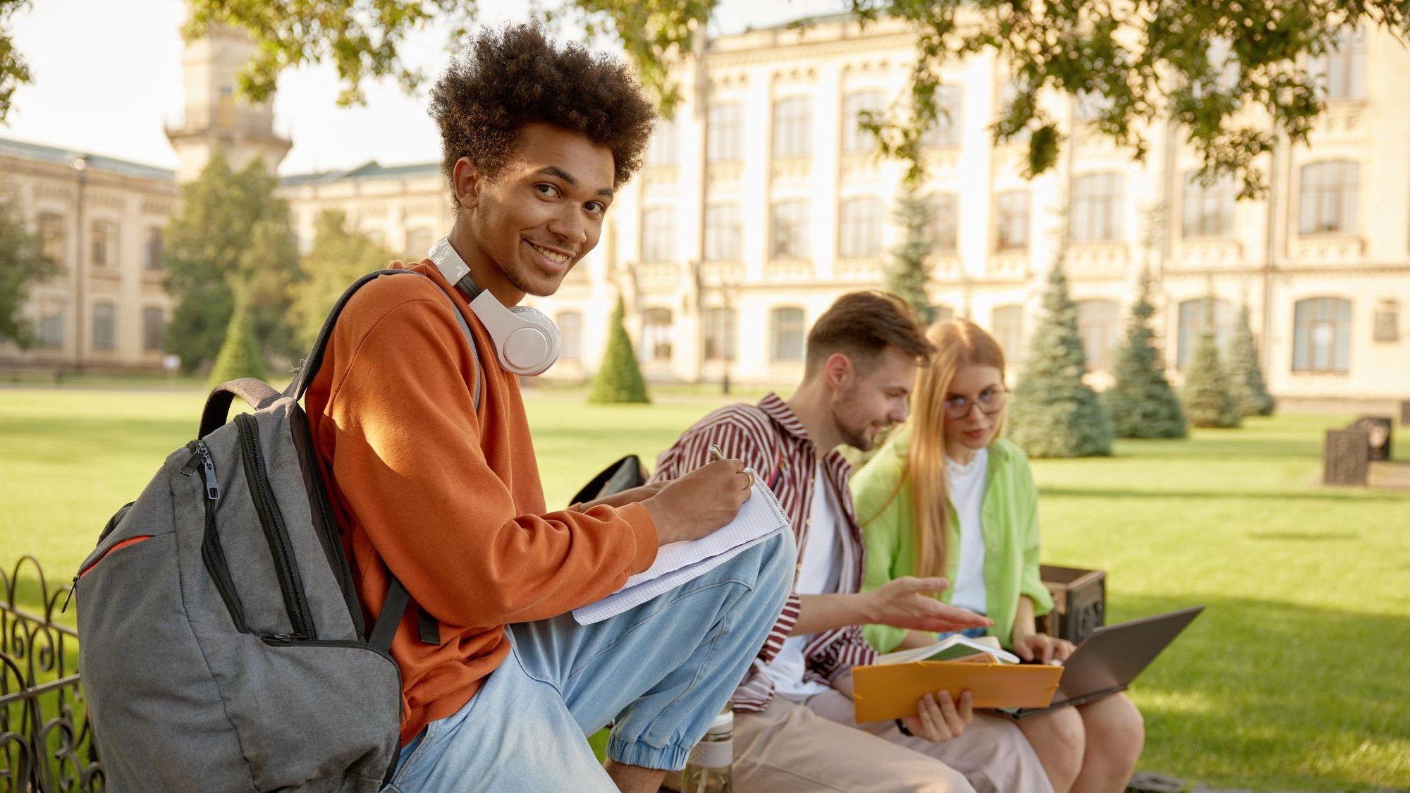 University students working on homework or creative project at campus outdoors