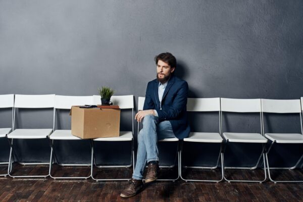 Man sits on a chair box with things dismissing discontent depression High quality photo