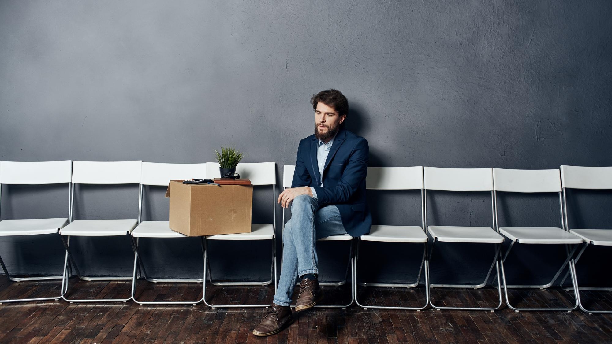 Man sits on a chair box with things dismissing discontent depression High quality photo