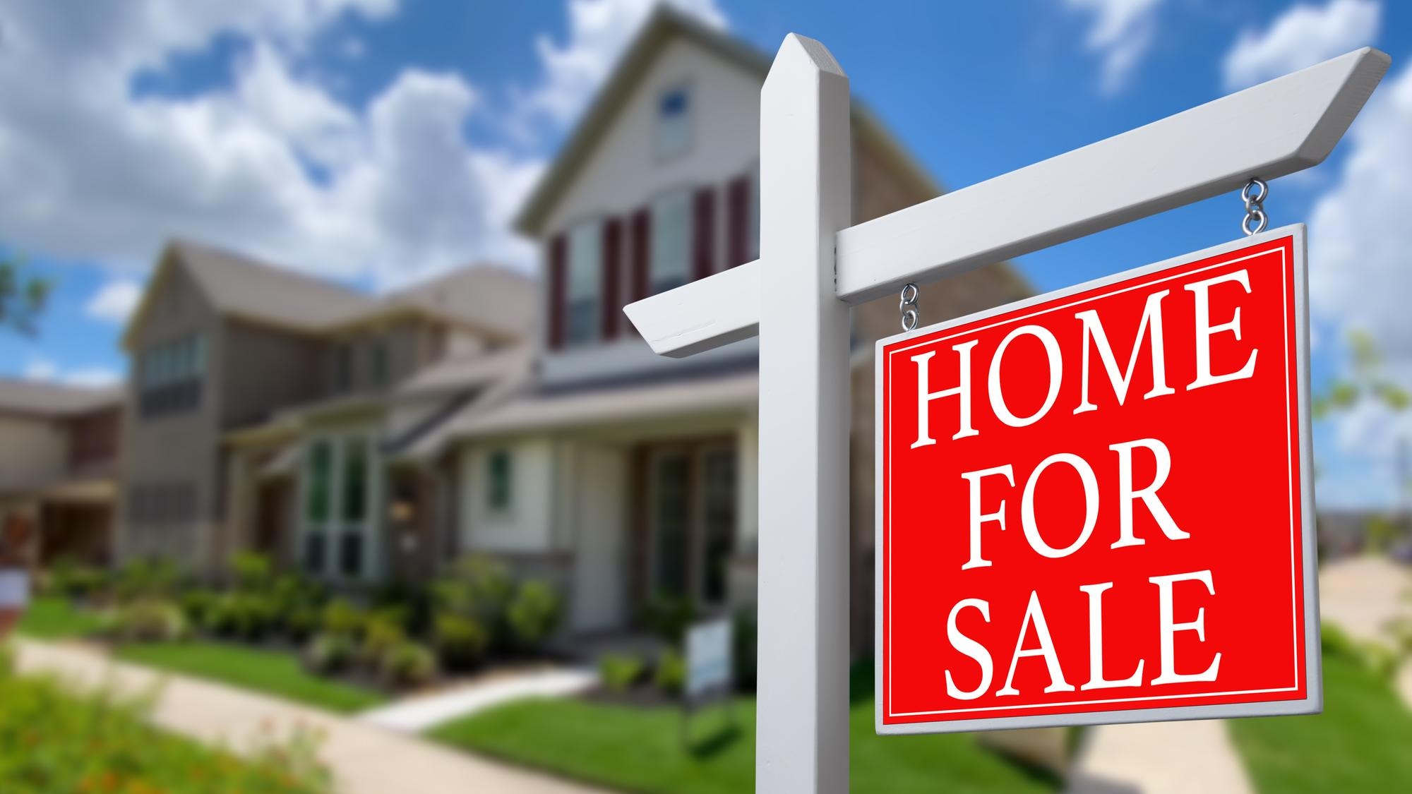 Home For Sale Real Estate Sign and Beautiful New House