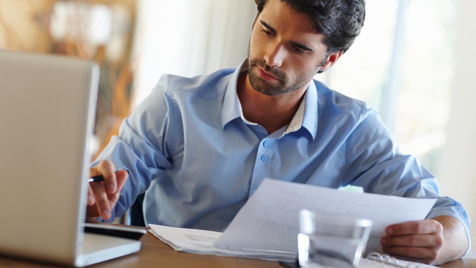 Man laptop and calculate in home office for budget planning and savings account for personal debt Male person computer and bills for audit with expenses tax and loan payment in living space