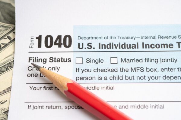 Tax Return form 1040 with USA America flag and dollar banknote US Individual Income
