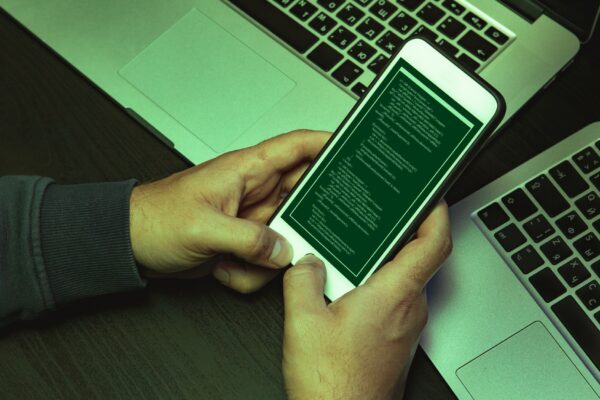 Close up of programmer of hacker hands typing a code