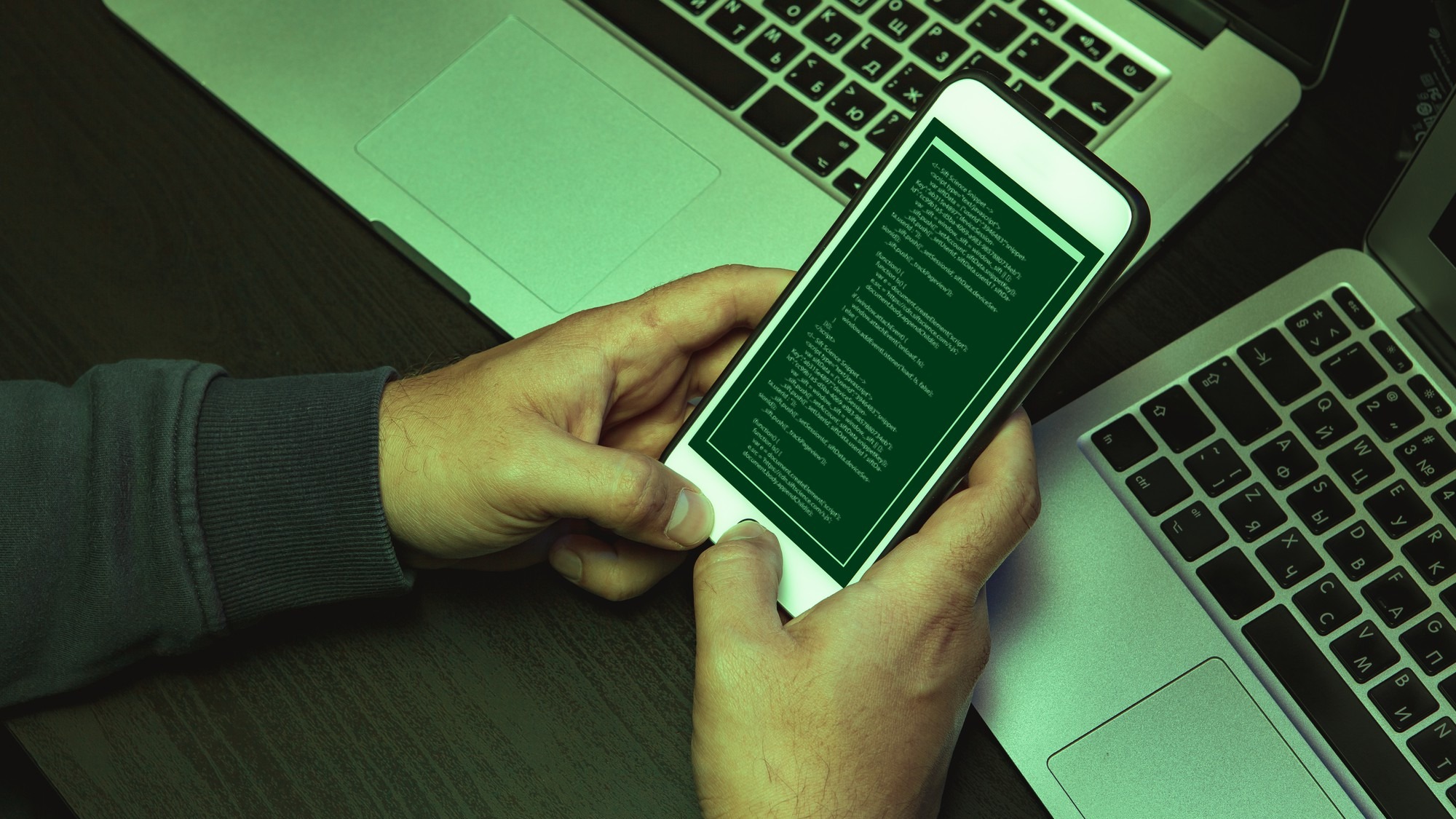 Close up of programmer of hacker hands typing a code
