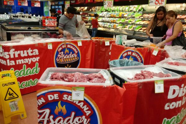 people standing beside raw meats in side market