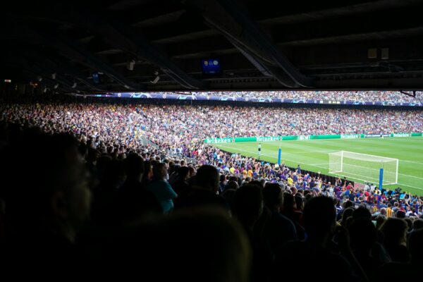 people watching football at stadium during daytime