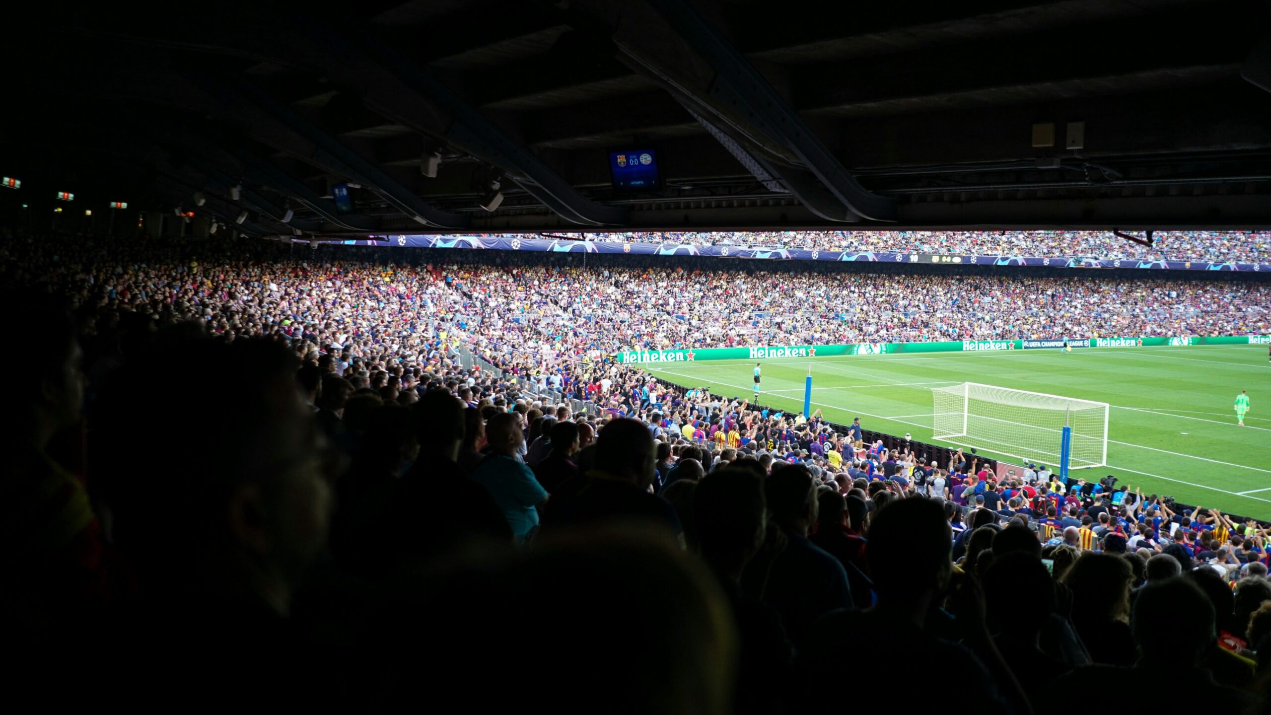 people watching football at stadium during daytime
