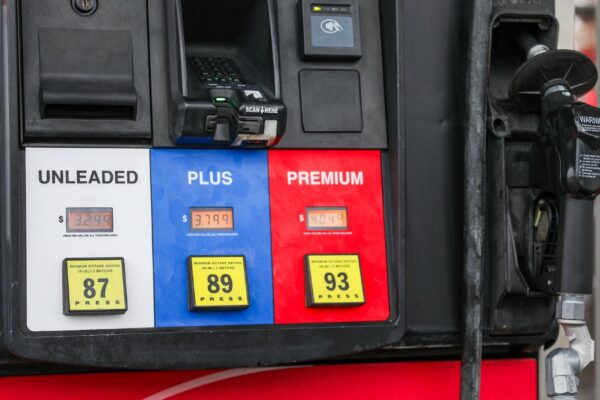 gas pump nozzle with rising numbers on the display symbolizing inflation and escalating gas prices